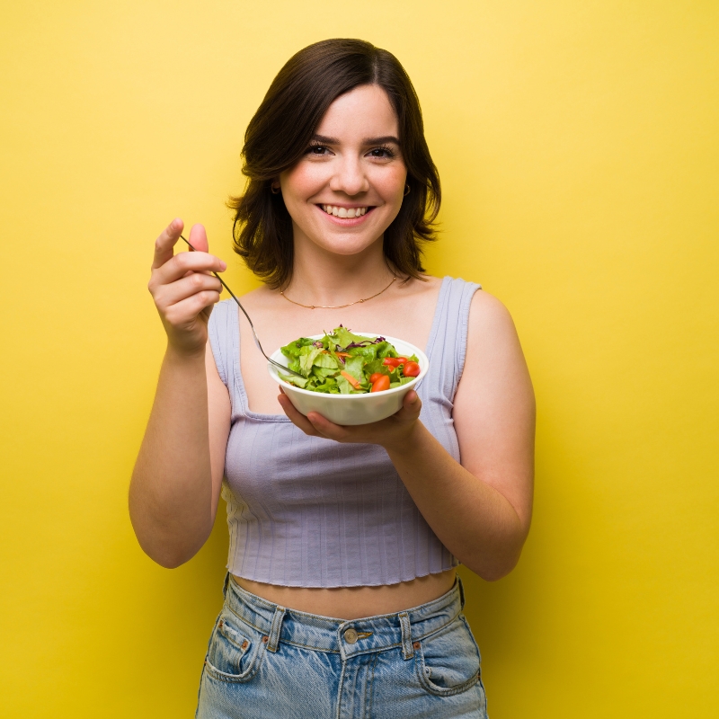 Smiling woman enjoying a healthy meal from the 1200-calorie diet plan